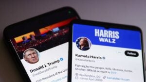 Two smartphones displaying the X accounts of Donald Trump and Kamala Harris.