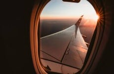 Sunset over California from the window seat of a plane with a sun star