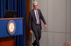 Fed chair Jerome Powell walks into a conference