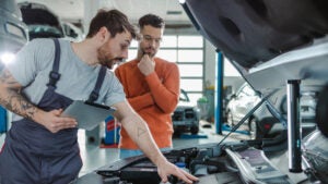 People looking at car