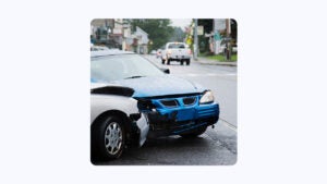 image of two cars colliding on the street