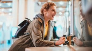 Woman purchasing a train ticket at the railroad station