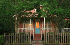 Cottage with weathered picket fence at twilight