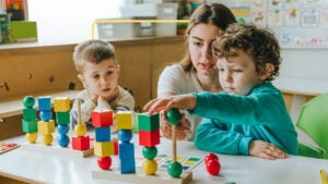 Kids playing with blocks at a school.