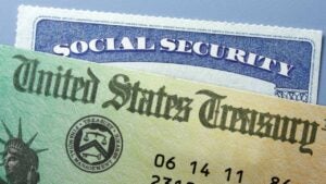 A U.S. Treasury check positioned on top of a Social Security card.