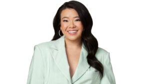 Personal finance influencer Vivian Tu wearing a light green suit