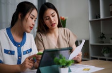 Two women reviewing documents at a table