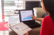 Person looking at a chart displayed on a laptop.