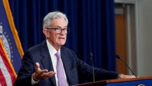 Federal Reserve Chair Jerome Powell speaking behind a podium.