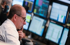 A stock trader watches his monitors on the floor of the Frankfurt Stock Exchange.