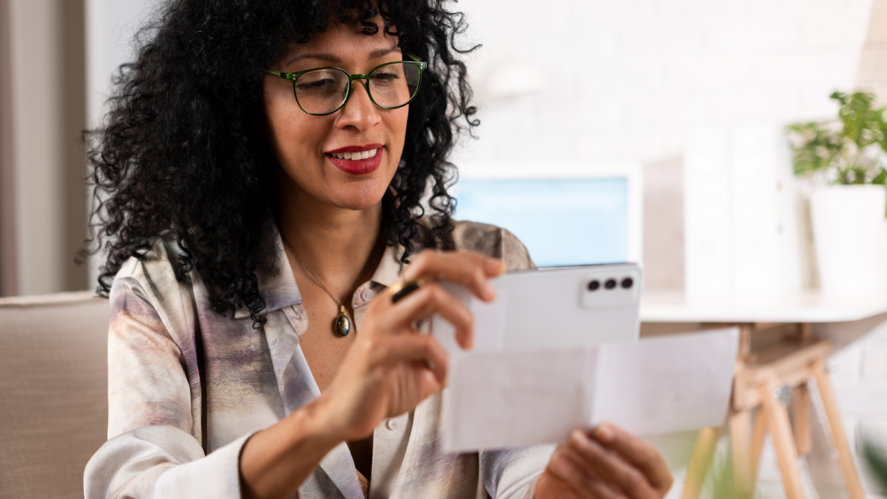 Woman depositing a bonus check using her mobile phone.