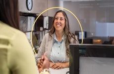 2 people at counter at a business speaking with each other