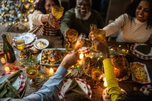 Family toasting over holiday dinner at home