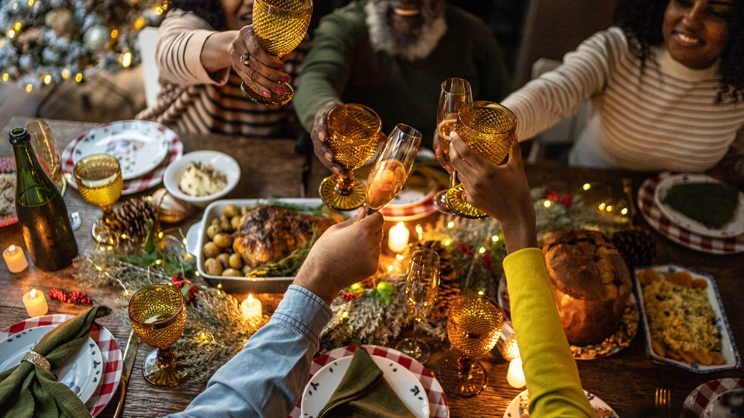 Family toasting over holiday dinner at home