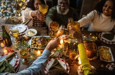 Family toasting over holiday dinner at home