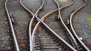 Three train tracks converging.