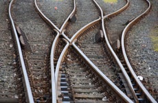 Three train tracks converging.