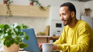 A man works on his laptop.