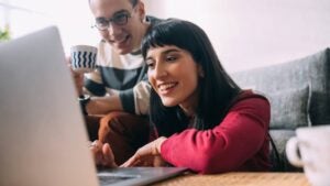 two people looking at computer smiling