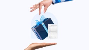 A hand drops a gift and receipt into another hand.