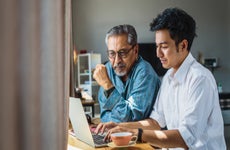 Father and son looking at laptop