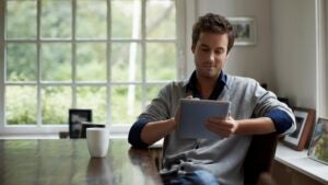 Man using digital tablet in cottage