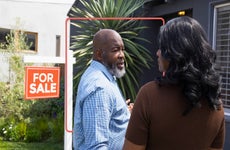 couple outside a home that's for sale, about to go inside and look around