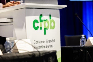 A lectern featuring the logo of the Consumer Financial Protection Bureau