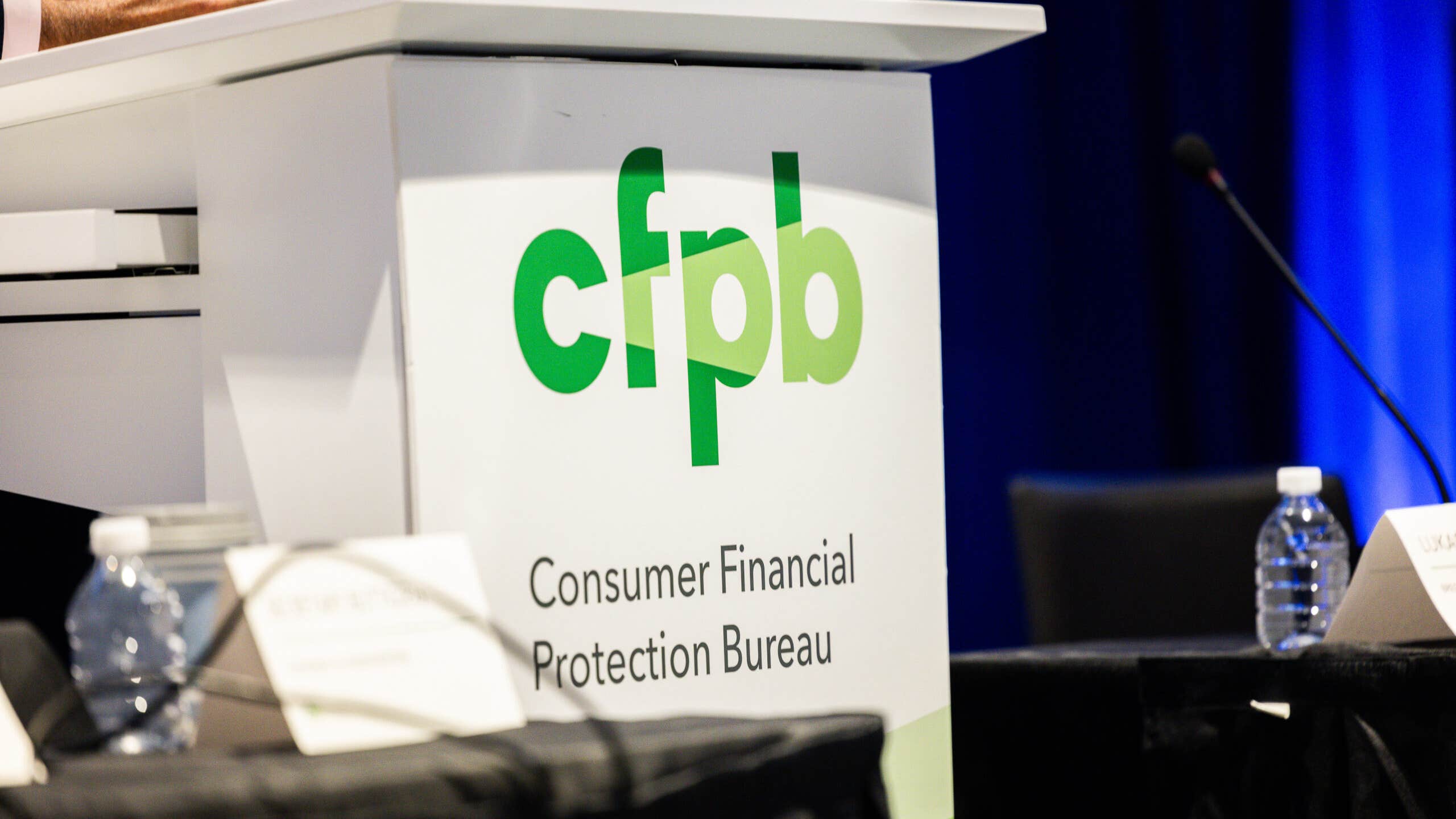 A lectern featuring the logo of the Consumer Financial Protection Bureau