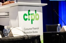 A lectern featuring the logo of the Consumer Financial Protection Bureau