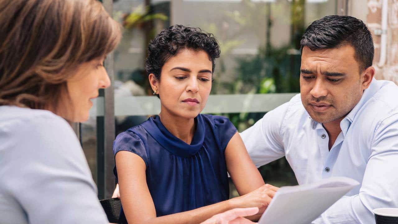 A couple receives professional advice from a financial planner.