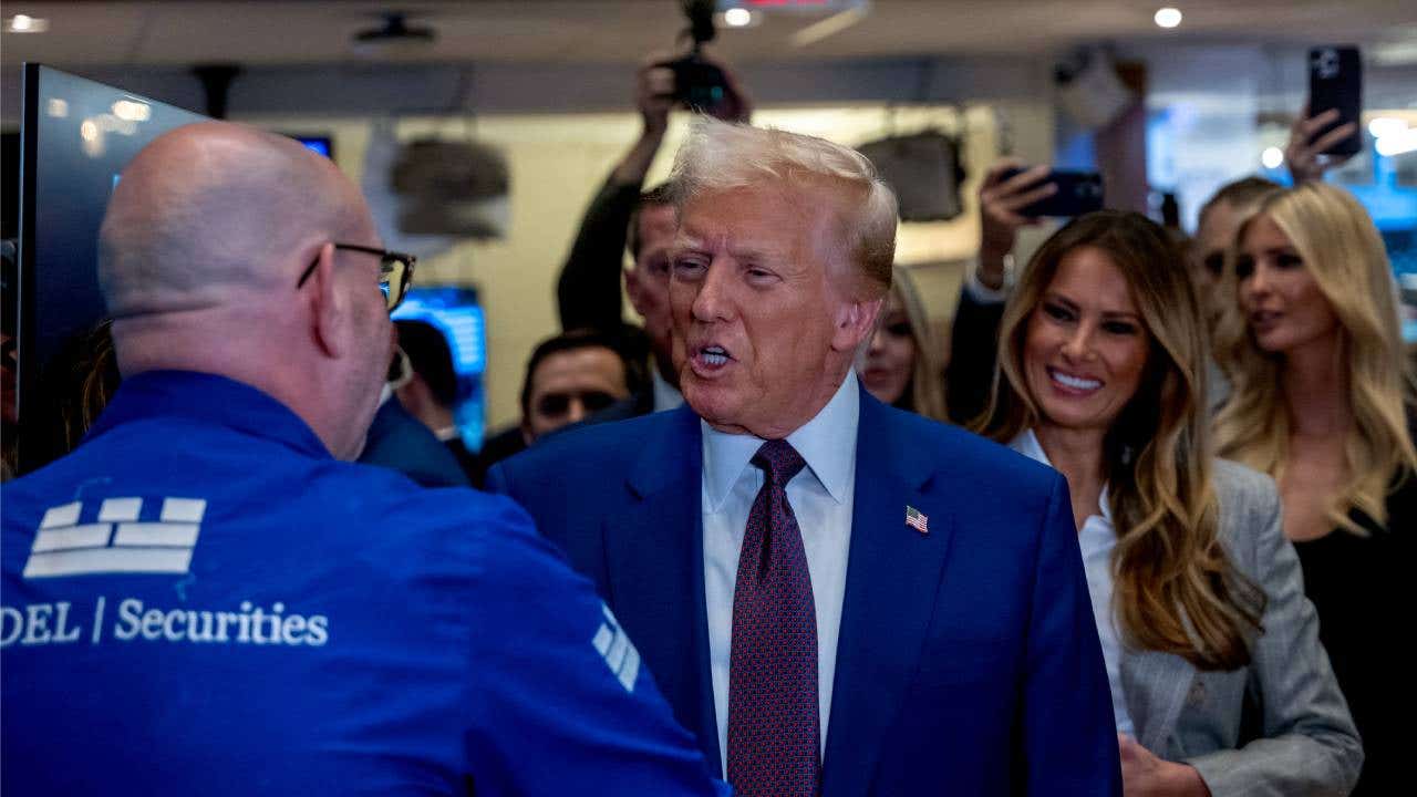 Donald Trump greeting someone while at the New York Stock Exchange.