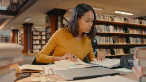 A woman studies in a university library