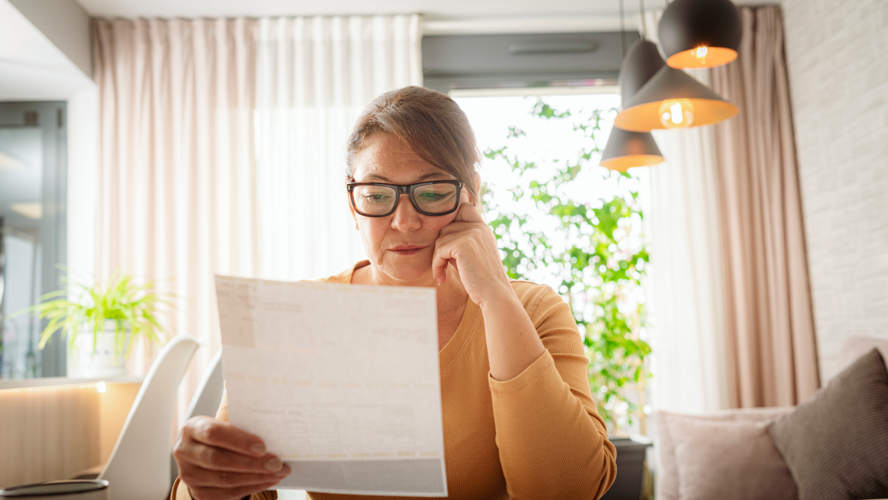 Woman looking at bills.