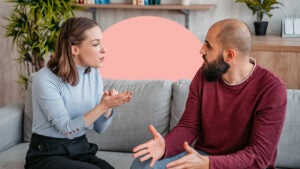 2 people sitting on a couch having a conversation