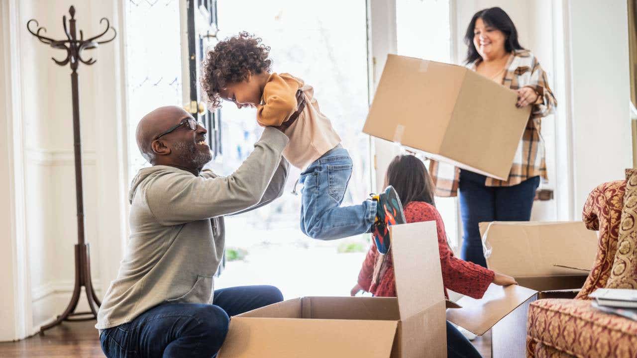 A family unpacks moving boxes.