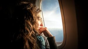 Woman looking out of airplane window