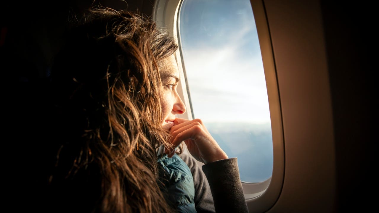 Woman looking out of airplane window