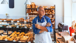 A small business owner pondering in their shop.