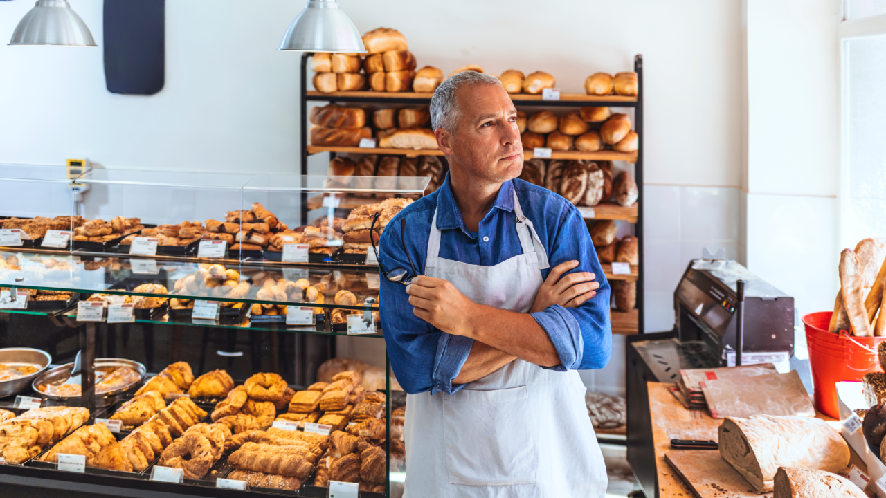 A small business owner pondering in their shop.