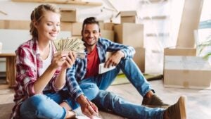 A young couple looks through U.S. banknotes.