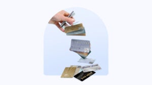 Design element with credit cards falling from a hand.