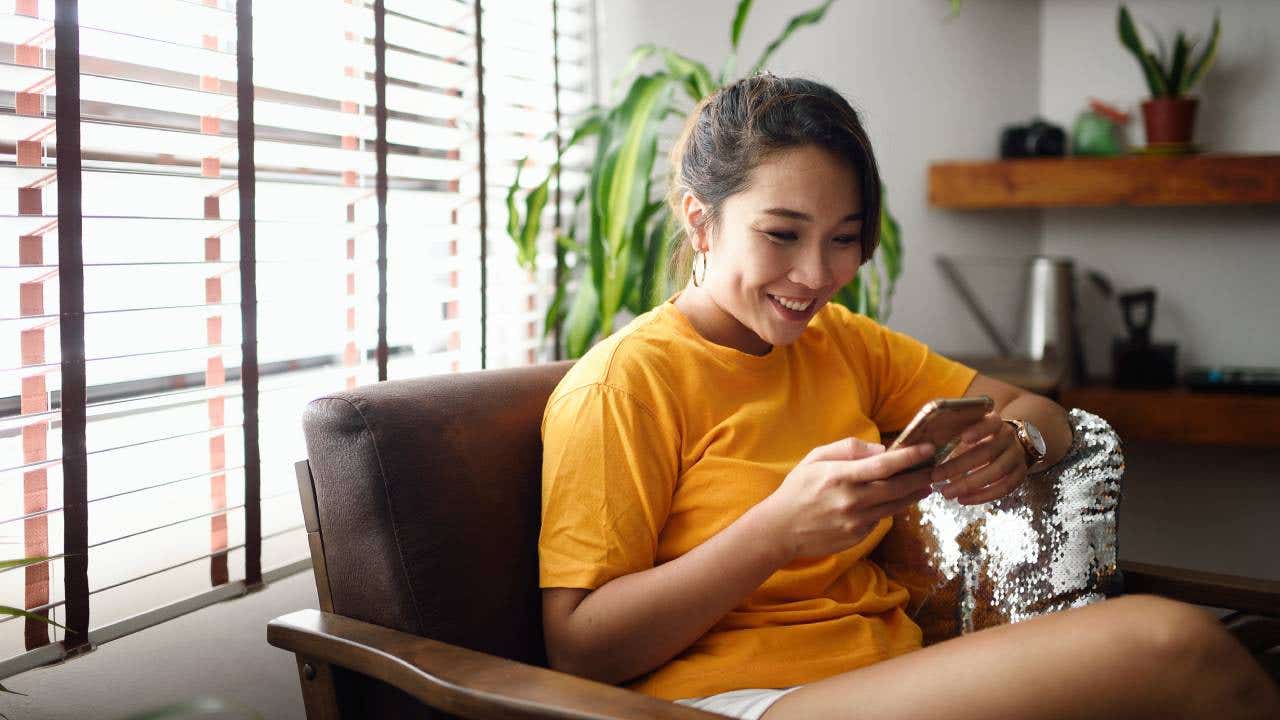 Woman using her smart phone at home