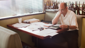 A man sitting with tax paperwork.