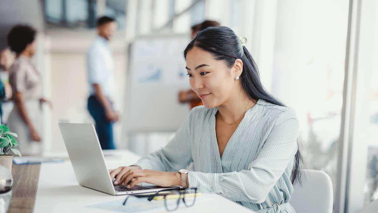 A woman works on her laptop.