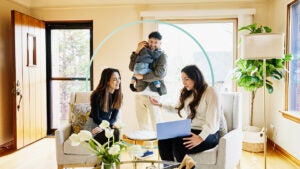 Design element of a family sitting with a real estate agent looking at a laptop