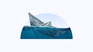 A semi-circle image containing a paper boat made of money sinking in water.