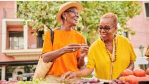 Two retirement-age women shop at a farmer's market.