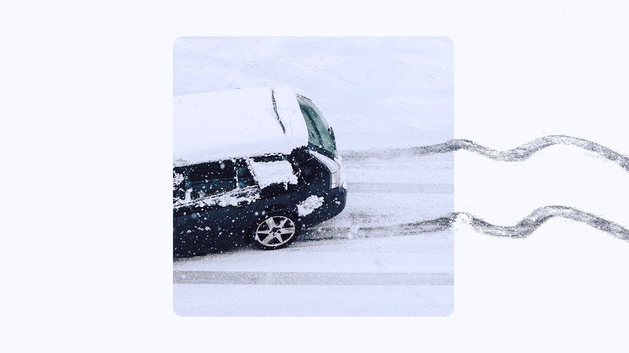 aerial view of suv driving on snowy road