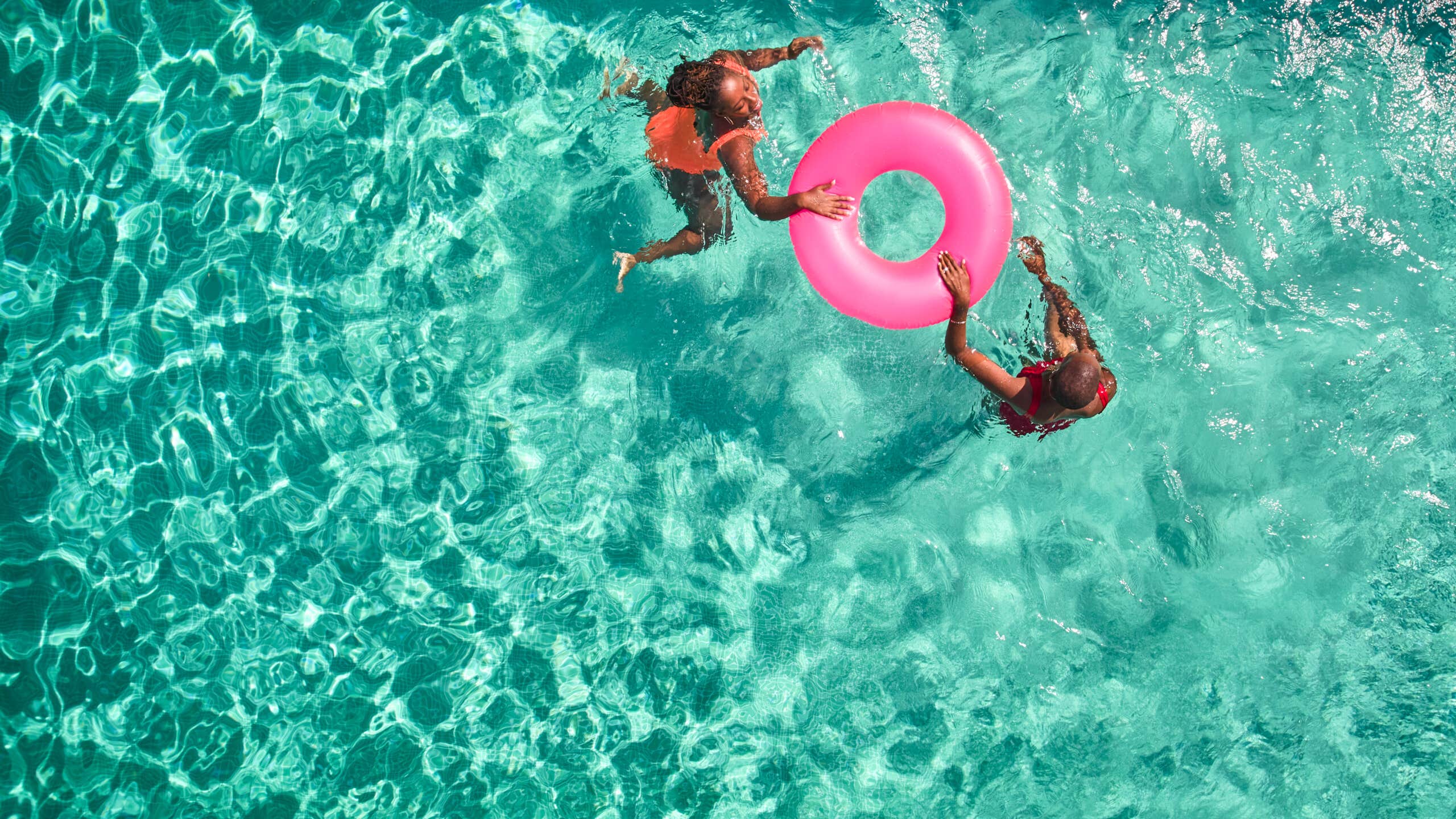 Overhead picture of two people with a innertube in a pool